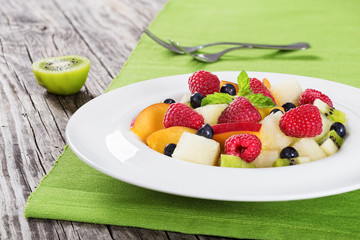 delicious fruit  and berry summer salad decorated with mint leav