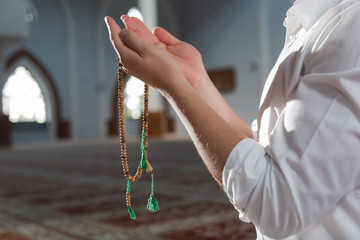 hand holding a muslim rosary