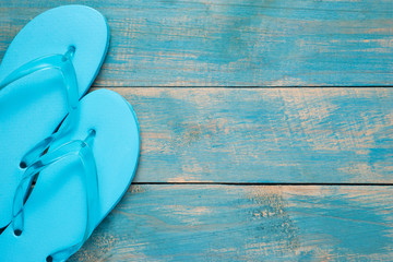 Flip-flop, Sandal, Summer. Blue flip flop sandals on blue wood