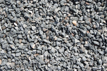Background composed of crushed gravel fine fraction in sunlight