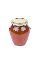 Apricot jam in a glass jar, isolated on white background