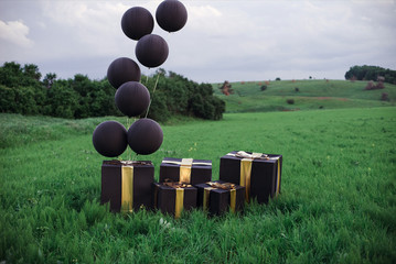 decoration black balloons and boxes with gold ribbon 