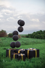 decoration black balloons and boxes with gold ribbon 