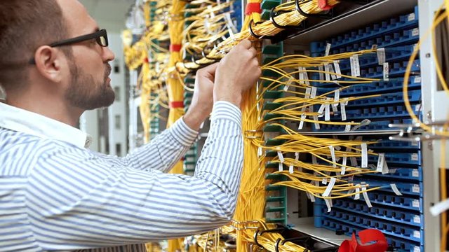Engineer working in data room. Slow motion.