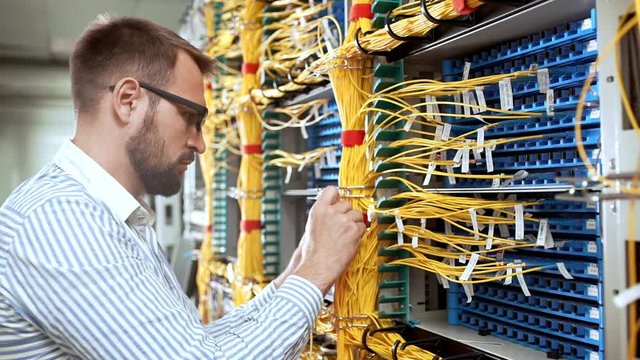 Engineer working in data room. Slow motion.