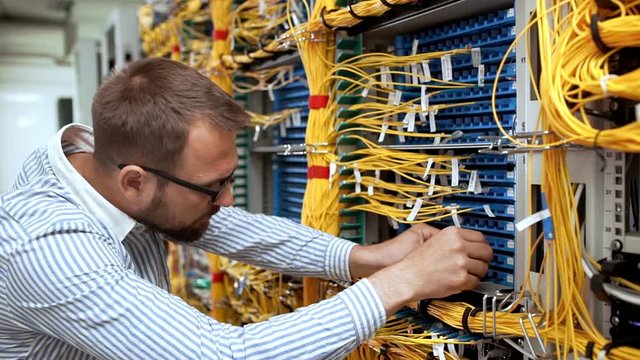 Engineer working in data room. Slow motion.