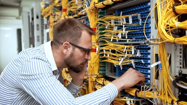 Engineer working in data room. Slow motion.