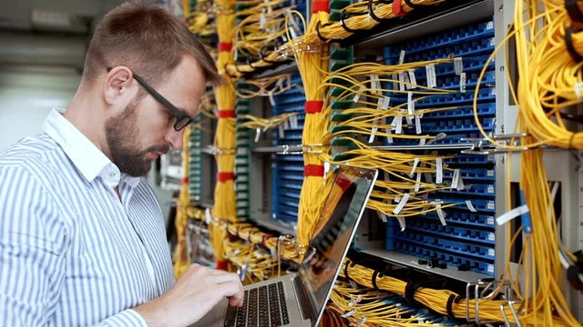 Engineer working in data room. Slow motion.