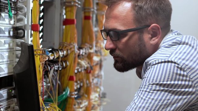 Engineer working in data room. Slow motion.