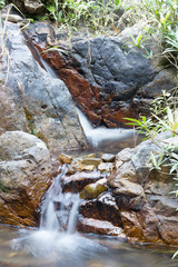 Rocks in stream with flowing water.
