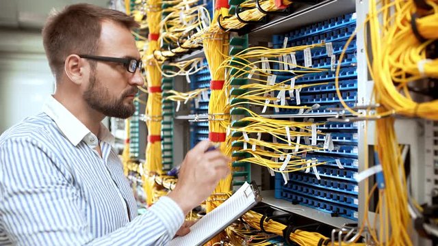 Engineer working in data room.