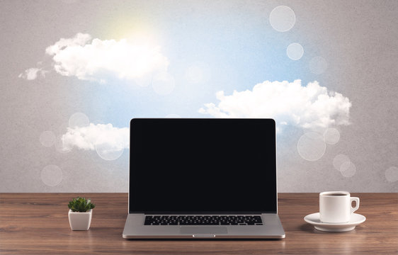 Bright sky with clouds and office desk