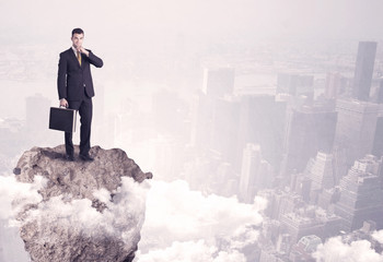 Winner business person standing on rock