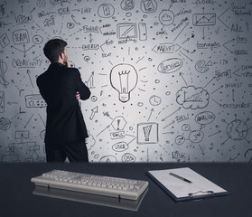 Businessman writing strategy plan on wall