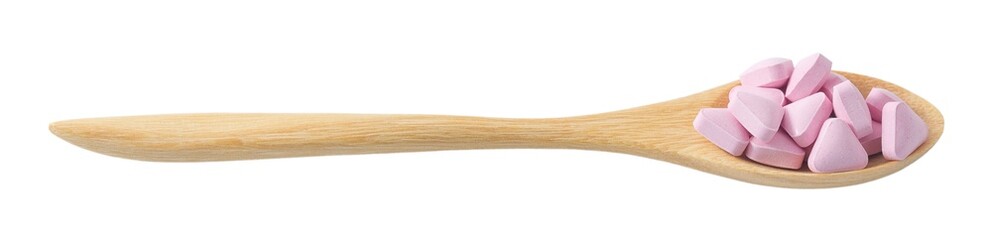 Wooden Spoon Full of Vitamins on White