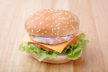 chicken and cheese hamburger on wood background