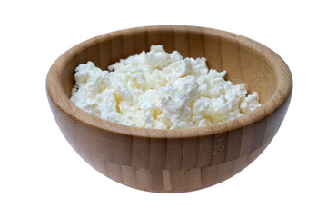 Cottage cheese in bowl on wooden table