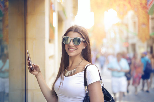 Young woman holding her smartphone