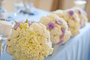 Nicely decorated wedding table with flowers and candles 