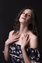 Tender brunette woman in dress with naked shoulders