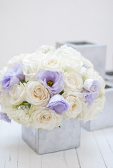 Beautiful white and blue flowers in silver vase.White background 