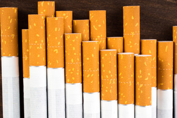 Cigarettes on wooden table close-up