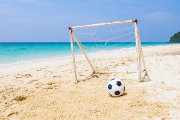 Football on the beach with net in the sunny day