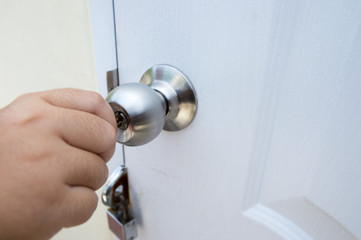 Unlocking the door knob.