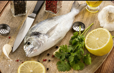 The fish with vegetables on a wooden board