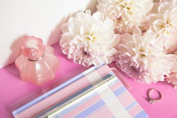 Obraz na płótnie Canvas Notebook, pen, perfume, ring, chrysanthemum on pink background.