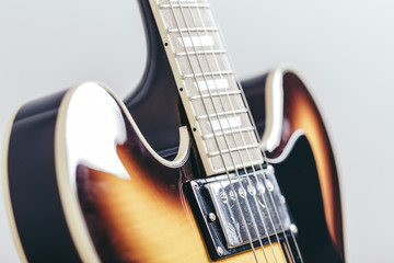 Electric guitar close up, vintage rock music instrument on sunburst color