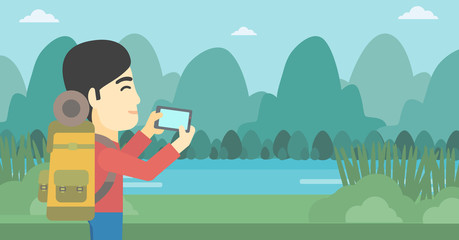 Man with backpack taking photo.