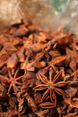 macro shot of a pile of dried Star anise, vertical