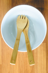 Empty Porcelain Salad Bowl With Wooden Spoon And Fork For Food Ingredient Mixing