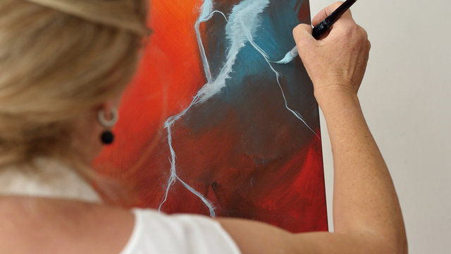 An artist is showing some techniques of painting