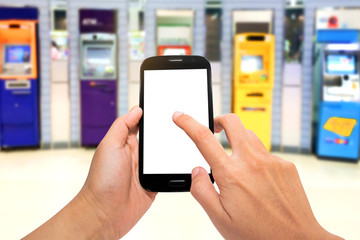 man holding mobile phone with blur ATM