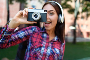 Joyful girl photographing nature outdoors