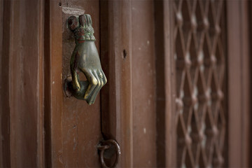 an unusual door handle and a keyhole on a wooden door