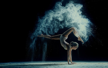 Fototapeta na wymiar Graceful woman dancing in cloud of dust