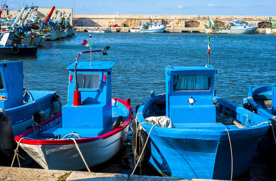 fishing boats anchored in the harbor. Carefully positioned nets and other fishing gear at sea