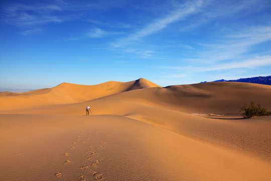 Middle-aged woman photographs dunes