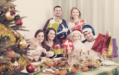 Fototapeta na wymiar Smiling Mature parents with kids celebrating Merry Christmas