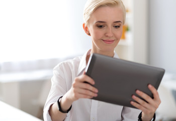 Fototapeta premium Woman holding tablet in front of him
