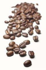 coffee beans spilled on a white background, vertical