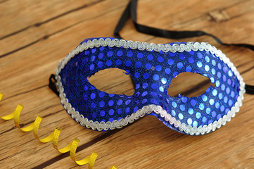 A blue mask isolated on a wooden background