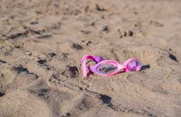 Swimming goggles on sand