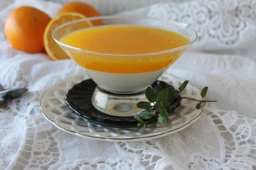 orange panna cotta with slices of oranges