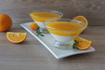 orange panna cotta with slices of oranges