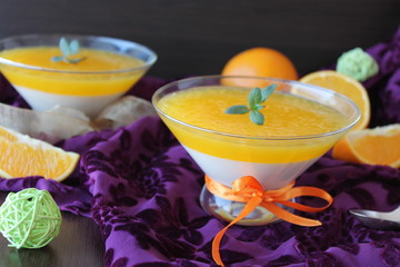 orange panna cotta with slices of oranges