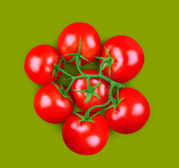 Minimal composition of tomatoes on green background